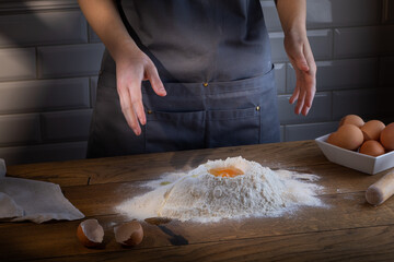 Chef during preparing ingredients for cooking dough for dumplings, pasta, bread, or pizza.  Cooking dumplings – step by step guide.