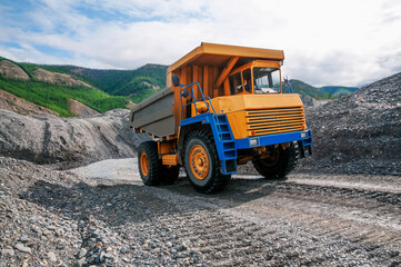 Mountainous dump truck is widely used for transporting and unloading rocks. Mining.