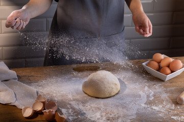 Obraz premium Chef preparing a portion of fresh dough. Cooking dumplings – step by step guide.