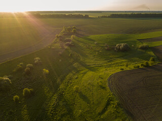 Aerial drone view. Hills near the lake at sunset.