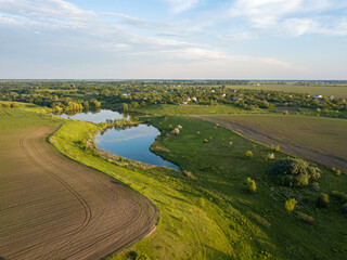 Aerial drone view. Country lake. Green grass on the shore.