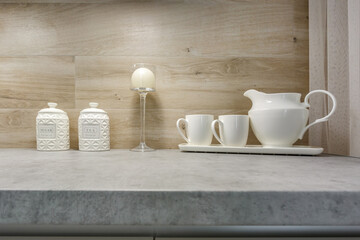 stylish vintage jars with different food and teapot in Interior of the modern kitchen apartment in minimalistic style