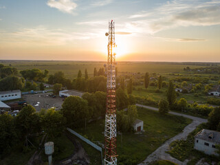 Aerial drone view. Cellular relay tower at sunset.