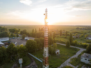 Aerial drone view. Cellular relay tower at sunset.