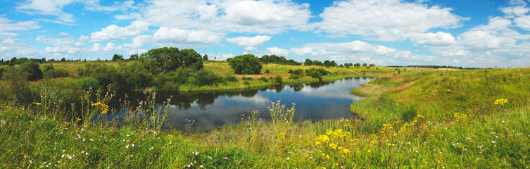 Summer landscape with river and blue sky