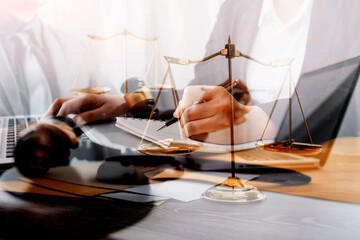 Business and lawyers discussing contract papers with brass scale on desk in office. Law, legal services, advice, justice and law concept picture with film grain effect