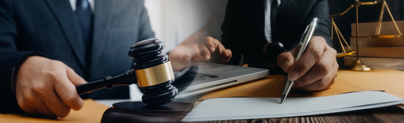 Business and lawyers discussing contract papers with brass scale on desk in office. Law, legal...