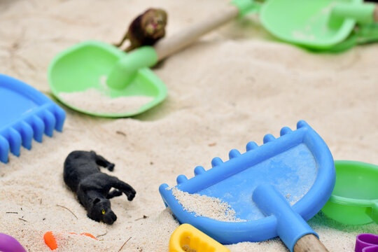 Children toys and animal models on the sand beach.