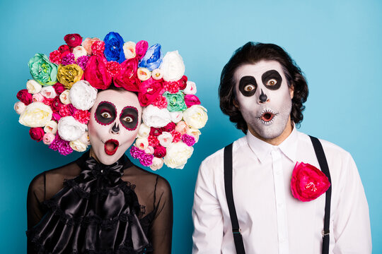 Photo of zombie ghost couple man lady shocked open mouth speechless find out themselves underworld wear black dress death costume roses headband suspenders isolated blue color background