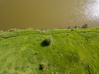 Aerial drone top view. Green shores of a country lake.
