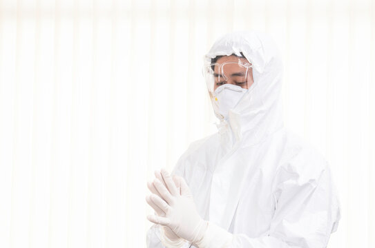 Lab technician or doctor wearing PPE kit, face shield, N95, and surgical gloves to prepare before starting nasopharyngeal swab sample for corona virus antigen test. A testing center to curb the spread - Powered by Adobe