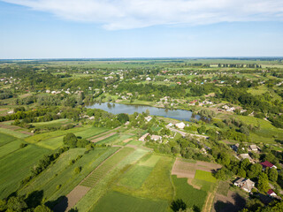 Lake among agricultural fields. Aerial drone view.