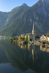 Fototapeta premium Famous beautiful Austrian mountain town of Hallstatt situated between the shore of Hallstatter See and slopes of the Dachstein massif. Salzkammergut region.UNESCO site in Austria. Travel background