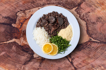 Feijoada. Traditional Brazilian Food Dish. Wood background. Top view. Copy space.