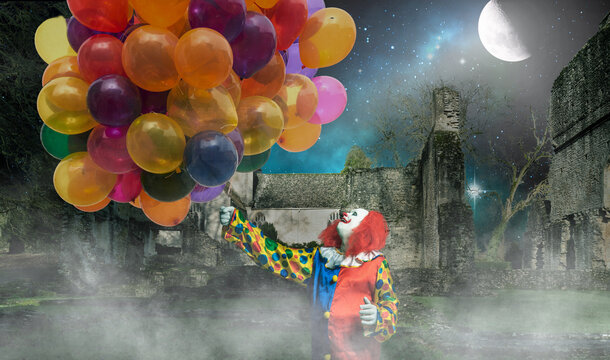 happy clown is holding lots of balloons against a creepy background