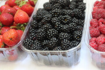 strawberries, blackberries and raspberries on white background