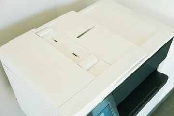 Close up photo of white printer machine in office