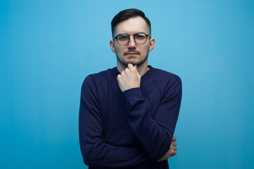 Pensive young man wearing casual clothes