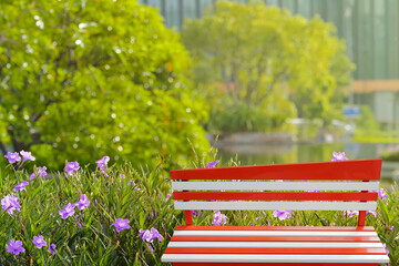 Colorful benches painted red and white with metal legs present a natural background decoration ,...