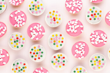 Colorful cupcakes on a white background.