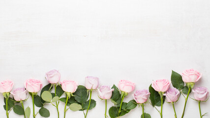 Flowers valentine day composition. Frame made of pink rose on gray background. Flat lay, top view, copy space.