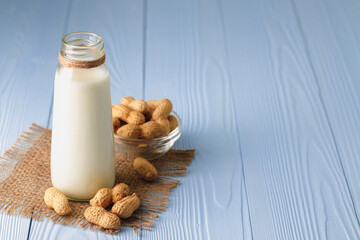 Vegan peanut milk in glass with peanuts