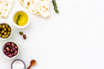 Fototapeta na wymiar Italian olives, oil, bread - appetizer and snacks - top view copy space