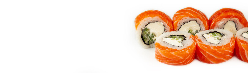 Sushi roll Philadelphia with cucumber on a white plate, classic Japanese sushi. Traditional Japanese food with maki. Delicious pieces of sushi. For the restaurant menu. copyspace