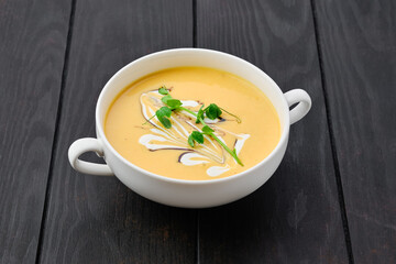 Pumpkin puree soup with barbecue sauce and sour cream