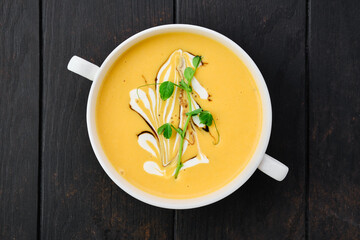Pumpkin puree soup with barbecue sauce and sour cream
