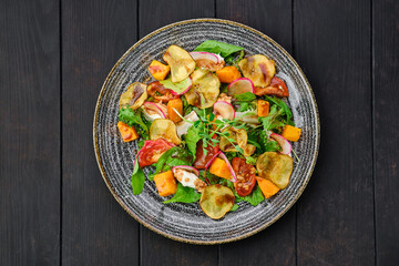 Salad with soft cheese, radish, pear, pumpkin and sun dried tomato