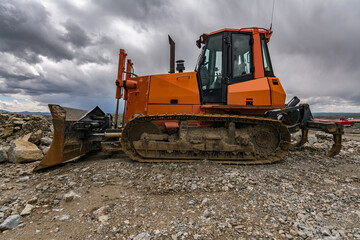 Excavator in a quarry extracting stone and rock