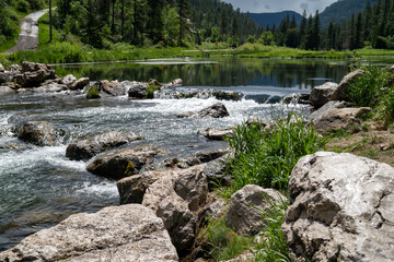 Rapids near the Old Spearfish Creek Dam in the Black Hills National Forest of South Dakota. Focus on the rocks