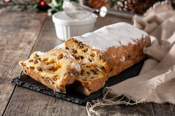 Christmas stollen fruit cake on wooden table.	Copy space