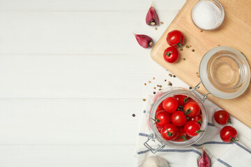 Fototapeta na wymiar Pickling jar with fresh ripe cherry tomatoes and spices on white wooden table, flat lay. Space for text