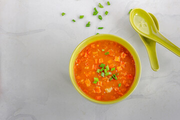 Vegan Vegetable Soup in a Bowl with Spoons on White Background Top Down Photo