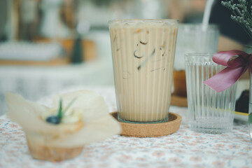 Iced latte coffee in glasses on table served with banana cake