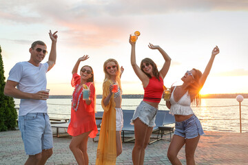 Group of happy people enjoying fun party outdoors