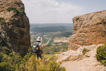 Woman takes in the view at Mallos de Riglos, Huesca, Pyrenees, Spain