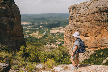A young athletic woman to take view at Mallos de Riglos, Pyrenees, Spa