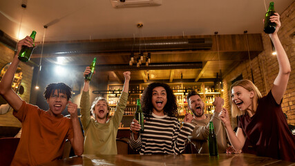 Scream it. Happy friends in the bar watching sports match on TV together, drinking beer and celebrating victory. People, leisure, friendship and entertainment concept