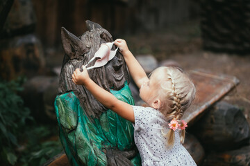 Little girl in medical mask in city park