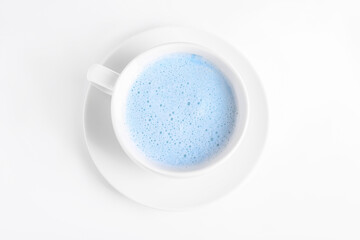 Blue matcha latte in cup on white background, top view