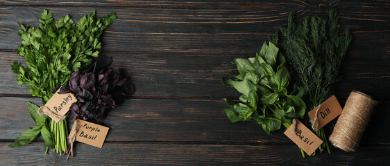 Different herbs on wooden background, top view