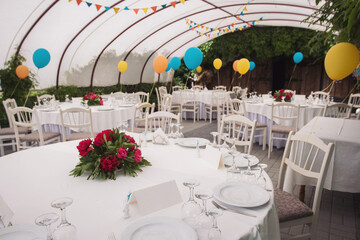 Holiday party decoration. The Colorful balloons attached to the table. Decorated balloons for birthday.