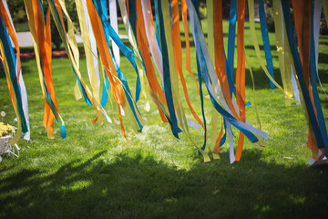 Obraz na płótnie Canvas Celebration outdoor party in the garden. Colorful ribbons fly in the wind.