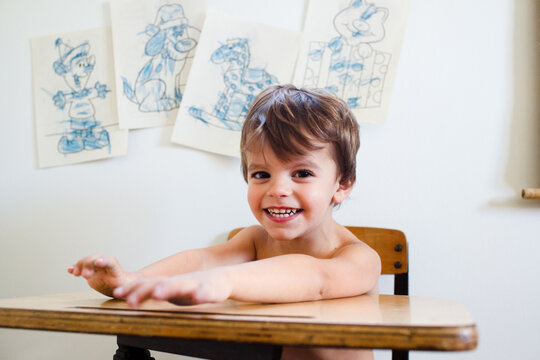 portrait of boy in front of blue coloring pages