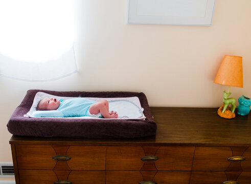 Photo Of Baby On Changing Pad On Dresser