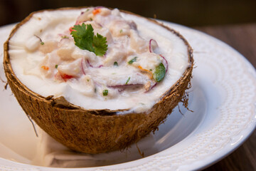 Ceviche served inside fresh coconut. Seafood ceviche, typical dish from Peru