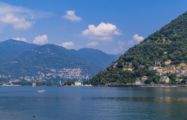 Fototapeta premium Motor boat on Lake Como, Italy with traditional Italian villas in the hills